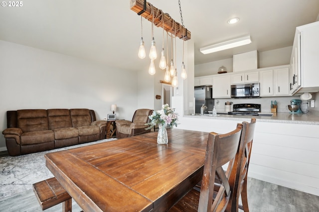 dining area with wood finished floors