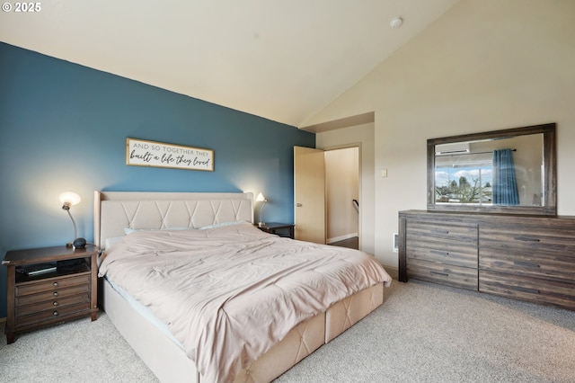 carpeted bedroom with high vaulted ceiling