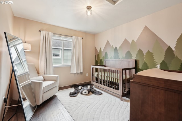 bedroom featuring wood finished floors and baseboards