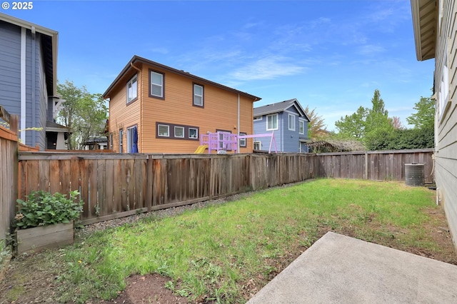 5298 Wales Dr, Eugene, OR 97402 - view of yard with central AC unit, a fenced backyard, and a patio area