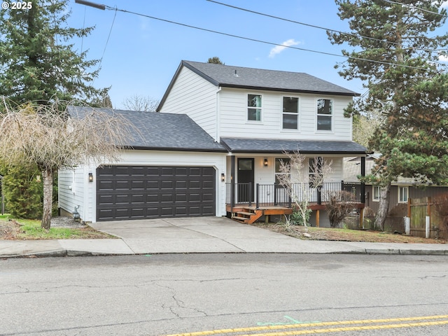 traditional home with a shingled roof, covered porch, driveway, and an attached garage