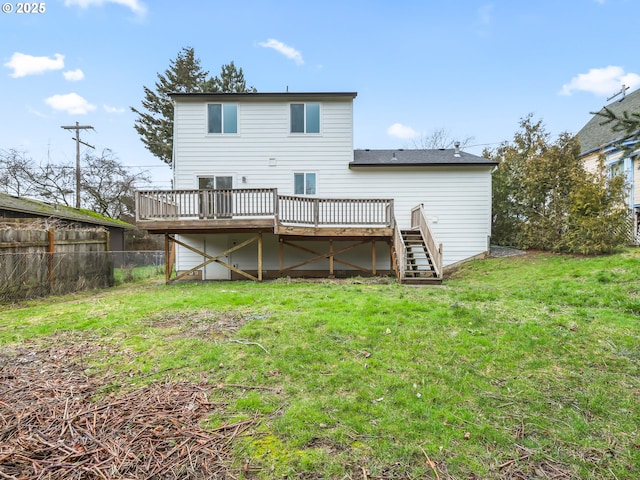 back of property with stairs, a yard, fence, and a wooden deck