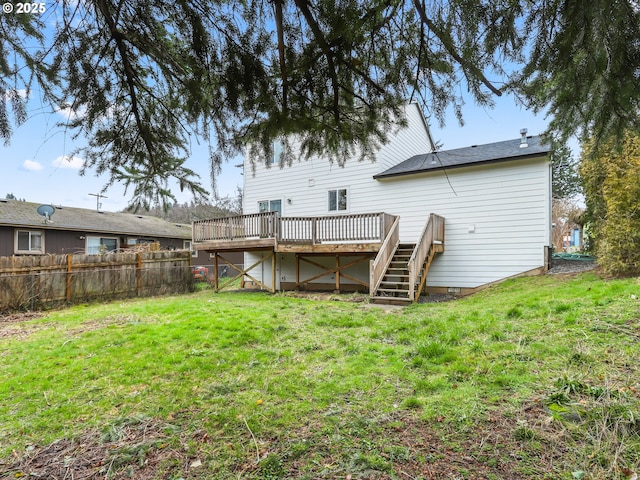 back of property featuring stairs, a deck, a lawn, and fence