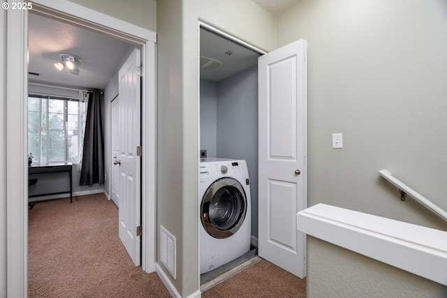 clothes washing area featuring washer / clothes dryer and carpet