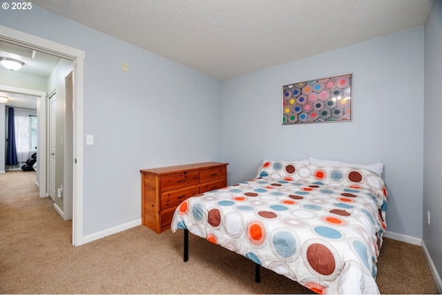 bedroom featuring light colored carpet and baseboards