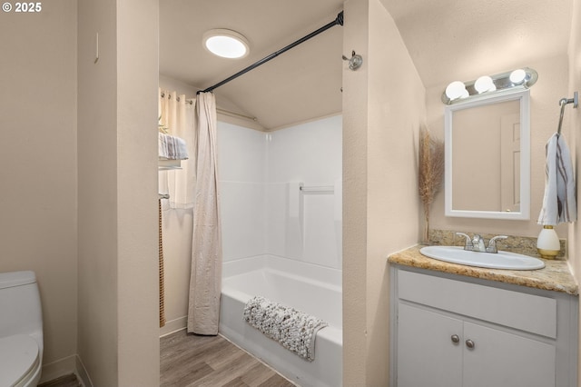 full bathroom featuring lofted ceiling, toilet, vanity, shower / bath combo, and hardwood / wood-style flooring