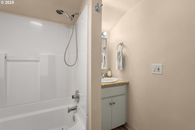 bathroom with vanity and bathtub / shower combination