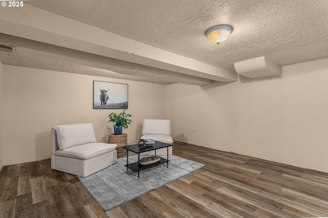 sitting room with hardwood / wood-style floors and a textured ceiling