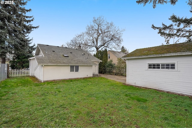 rear view of house featuring a yard