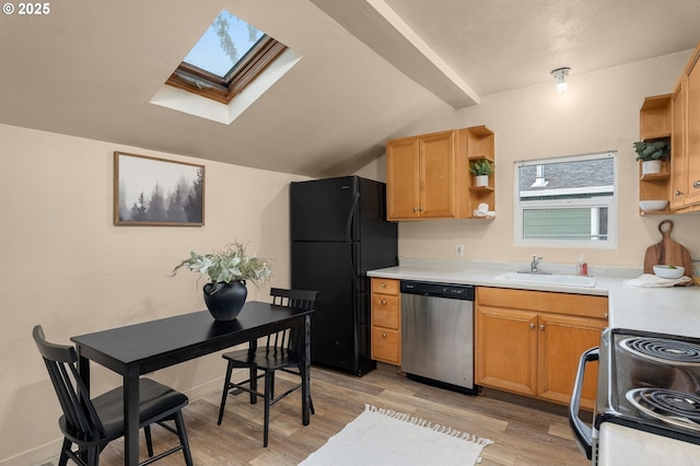 kitchen with black refrigerator, sink, stainless steel dishwasher, electric range, and light wood-type flooring