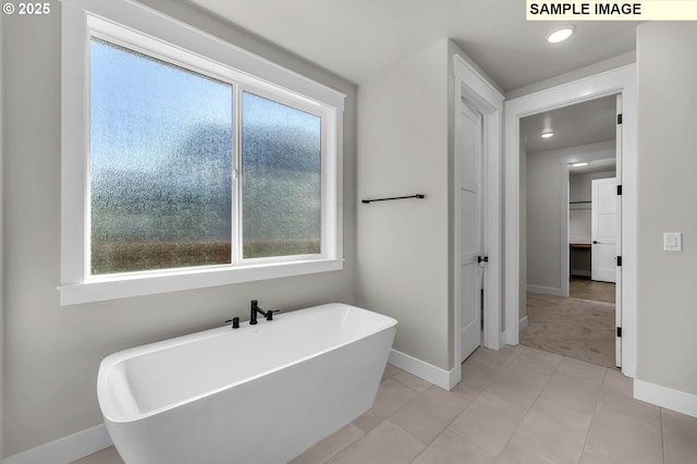 bathroom featuring tile patterned flooring and a bathing tub