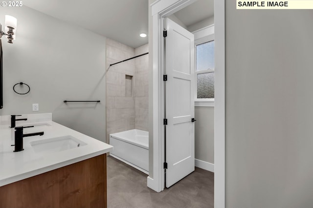 bathroom featuring vanity, tiled shower / bath combo, and concrete flooring