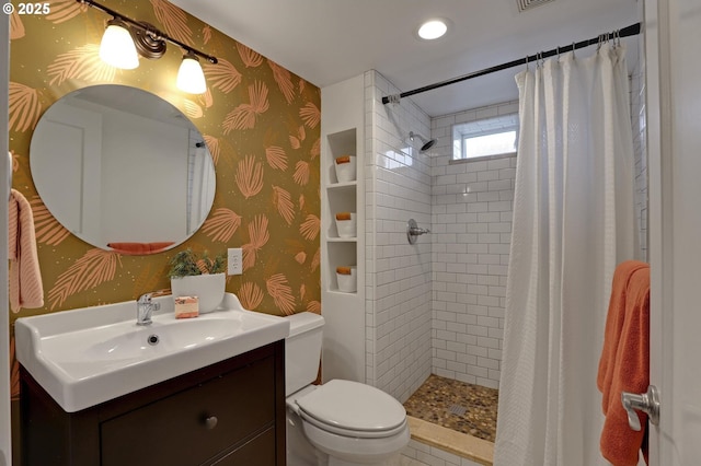 bathroom featuring toilet, a stall shower, wallpapered walls, and vanity