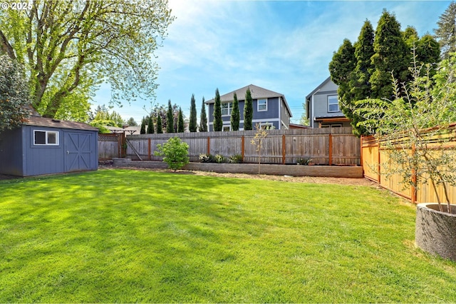 view of yard with an outbuilding, a storage unit, and a fenced backyard