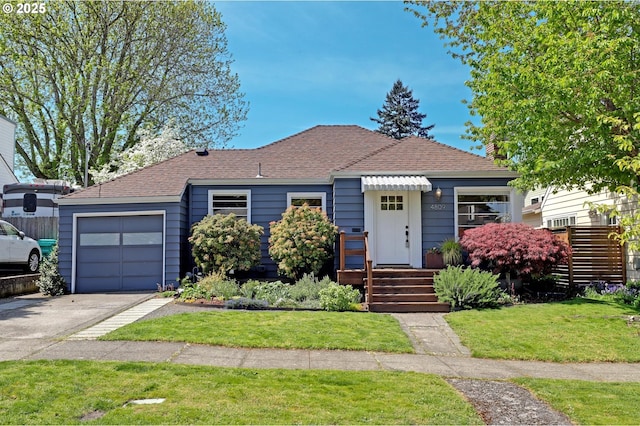 view of front of home featuring driveway, roof with shingles, a front lawn, and an attached garage