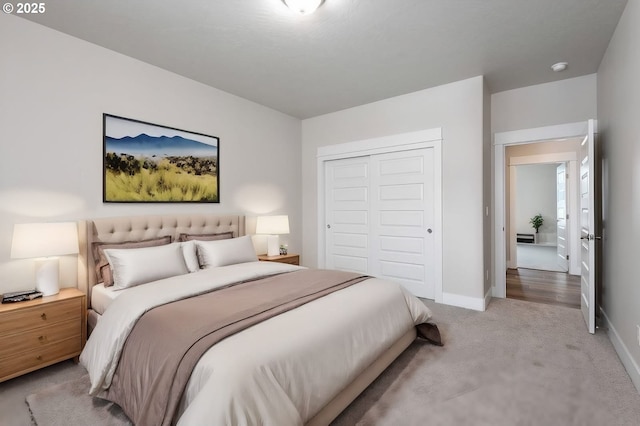 bedroom featuring light colored carpet and a closet