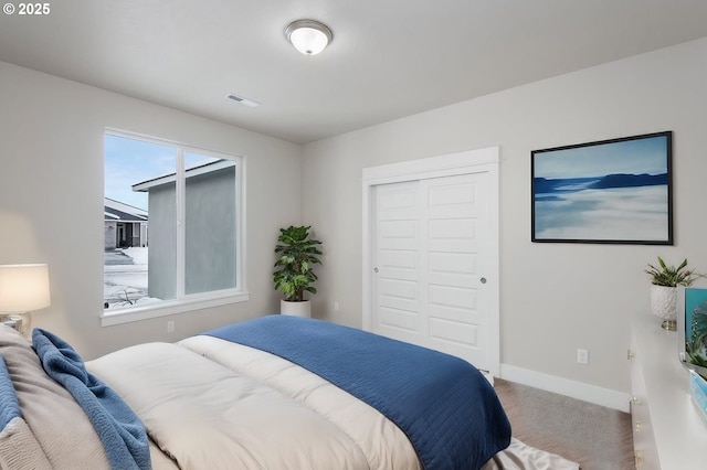 bedroom with a closet and carpet flooring