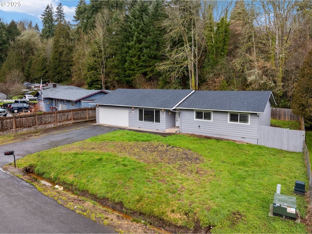 single story home featuring a garage and a front lawn