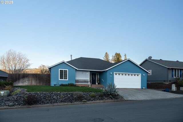721 N Summerwood St, Roseburg, OR 97471 - ranch-style house with fence, an attached garage, driveway, a front lawn, and a shingled roof