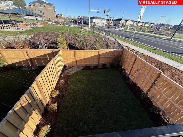 view of yard with a gazebo, a residential view, and a fenced backyard