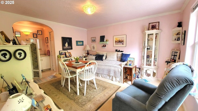 dining space with crown molding and arched walkways