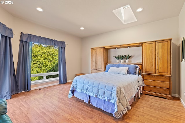 5220 SW Neal Ave, Waldport, OR 97394 - bedroom featuring a skylight, light wood-style floors, baseboards, and recessed lighting