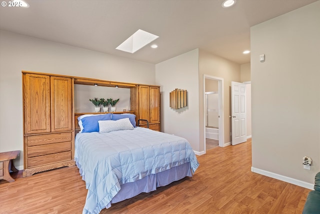 5220 SW Neal Ave, Waldport, OR 97394 - bedroom featuring a skylight, light wood-style flooring, baseboards, recessed lighting, and connected bathroom