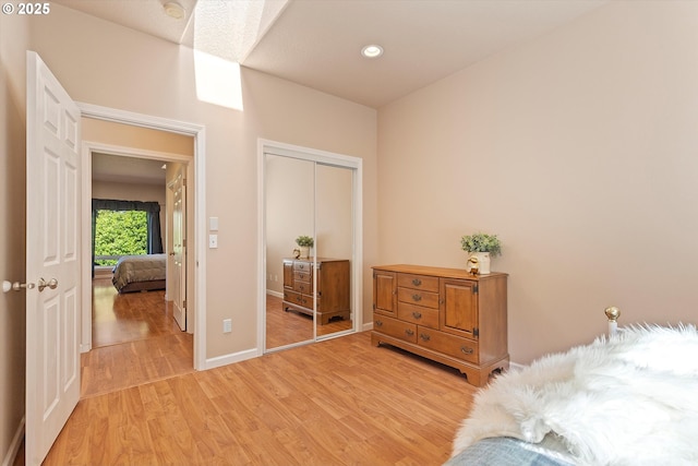 5220 SW Neal Ave, Waldport, OR 97394 - bedroom featuring light wood-style flooring, a closet, and baseboards