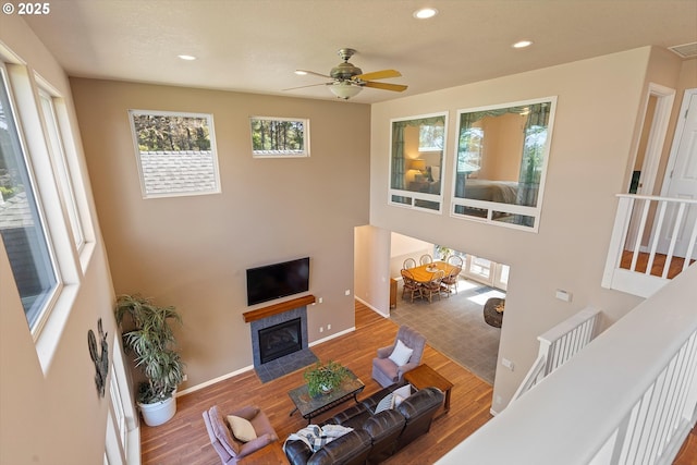 5220 SW Neal Ave, Waldport, OR 97394 - living room featuring healthy amount of natural light, recessed lighting, wood finished floors, baseboards, and ceiling fan
