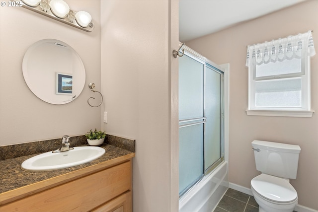 5220 SW Neal Ave, Waldport, OR 97394 - bathroom featuring tile patterned floors, vanity, toilet, combined bath / shower with glass door, and baseboards