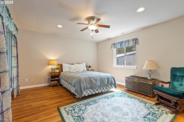 5220 SW Neal Ave, Waldport, OR 97394 - bedroom featuring wood finished floors, baseboards, recessed lighting, a textured ceiling, and ceiling fan