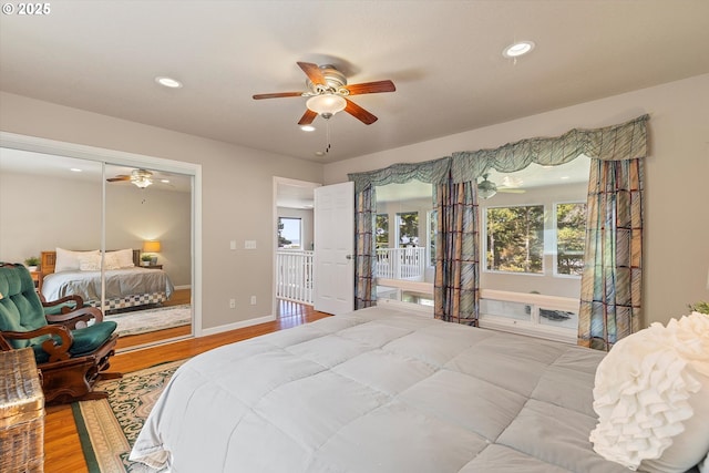 5220 SW Neal Ave, Waldport, OR 97394 - bedroom with wood finished floors, recessed lighting, baseboards, a closet, and a ceiling fan