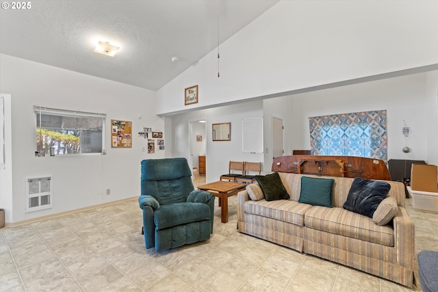 5220 SW Neal Ave, Waldport, OR 97394 - living room featuring heating unit, a textured ceiling, high vaulted ceiling, and baseboards