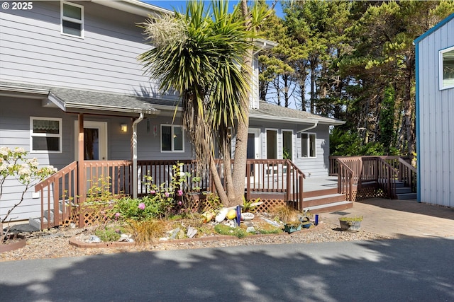 5220 SW Neal Ave, Waldport, OR 97394 - view of front of property with roof with shingles and a porch