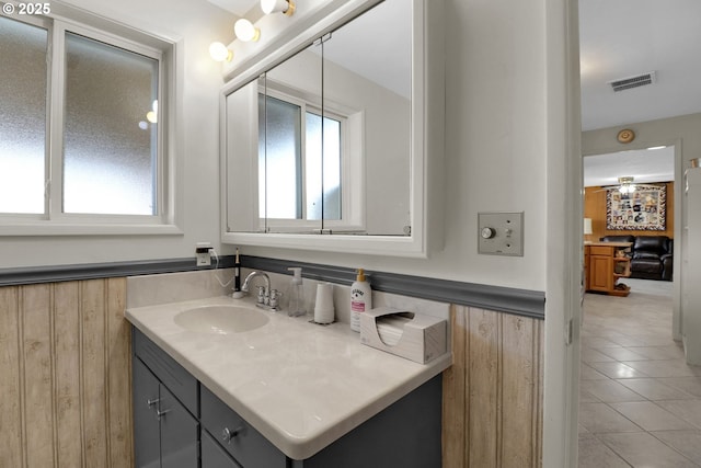 bathroom with visible vents, vanity, and tile patterned flooring