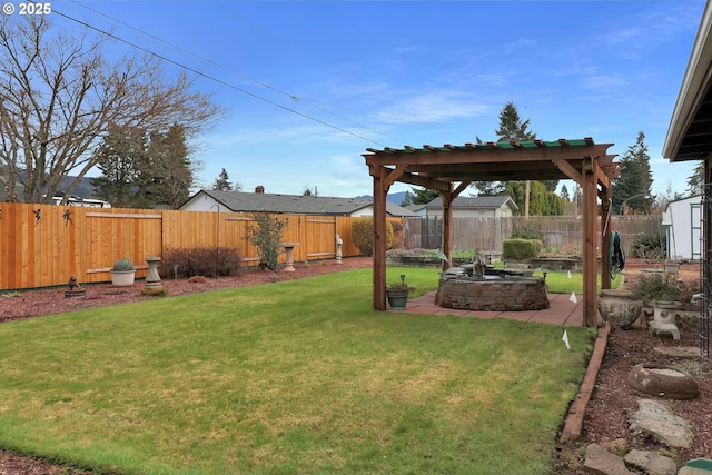 view of yard featuring a patio area, a fenced backyard, and an outdoor fire pit