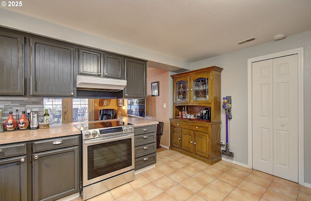 kitchen featuring stainless steel range with electric cooktop and light tile patterned flooring