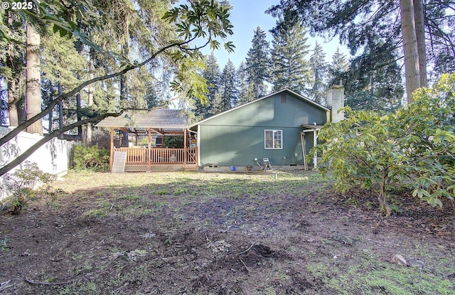 back of house featuring a wooden deck