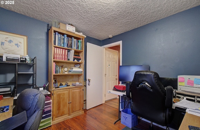 office area featuring dark hardwood / wood-style flooring and a textured ceiling