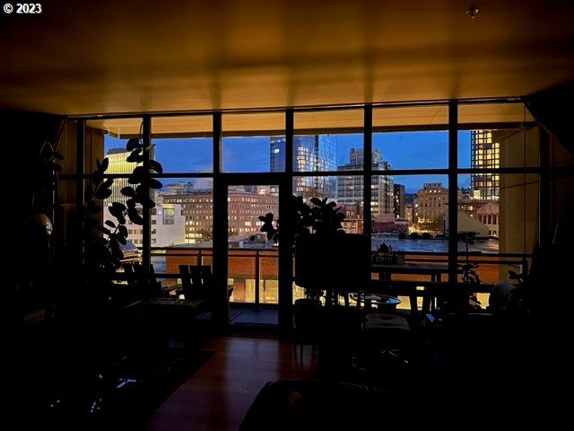 1025 NW Couch St Unit 613, Portland, OR 97209 - dining room with a wall of windows, wood finished floors, and a city view