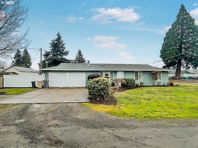 single story home with a garage, driveway, a front yard, and fence