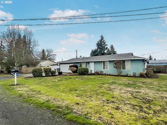 ranch-style home with fence and a front lawn