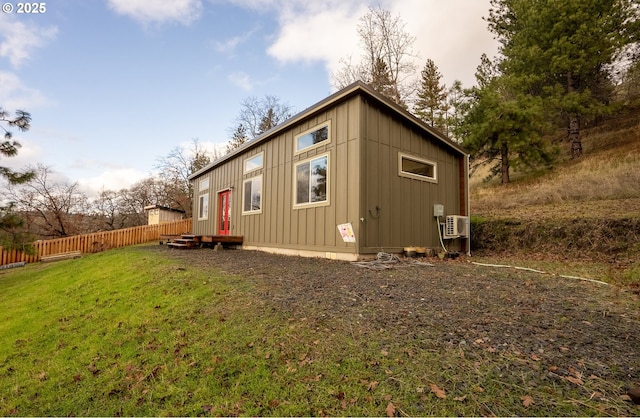 rear view of property featuring a yard