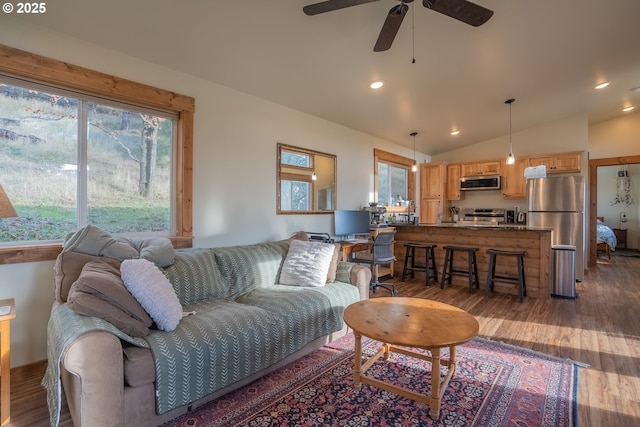 living room with dark wood-type flooring, ceiling fan, and lofted ceiling