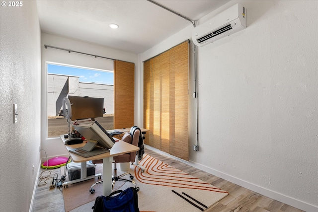 1905 2nd St, Baker City, OR 97814 - workout room featuring an AC wall unit, wood finished floors, baseboards, and a textured wall