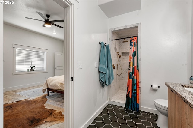 1905 2nd St, Baker City, OR 97814 - full bathroom with a tile shower, toilet, vanity, baseboards, and a ceiling fan