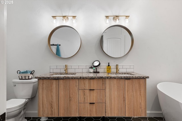 1905 2nd St, Baker City, OR 97814 - bathroom featuring double vanity, a freestanding tub, tile patterned flooring, and toilet