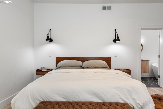 1905 2nd St, Baker City, OR 97814 - bedroom with wood finished floors, baseboards, and ensuite bath