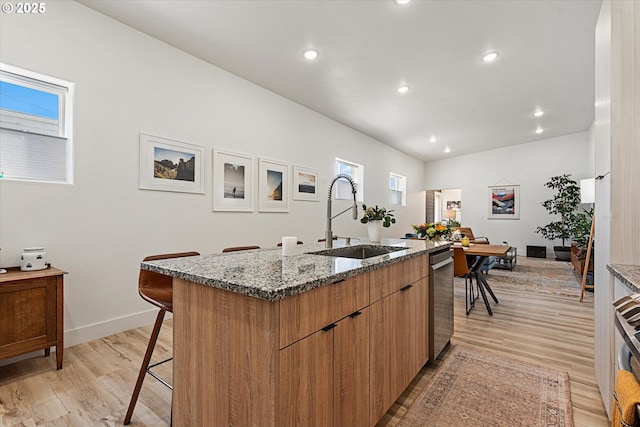 1905 2nd St, Baker City, OR 97814 - kitchen with a sink, dishwasher, a center island with sink, a kitchen breakfast bar, and stone counters