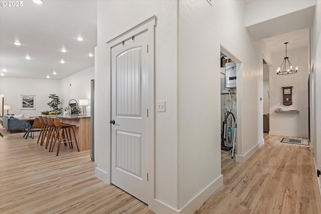 1905 2nd St, Baker City, OR 97814 - corridor featuring light wood finished floors, recessed lighting, baseboards, and a chandelier